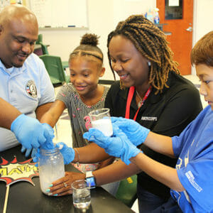 AmeriCorps members leading STEM activity