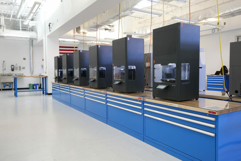 Manufacturing machines lined up in the Additive Manufacturing Innovation Lab.