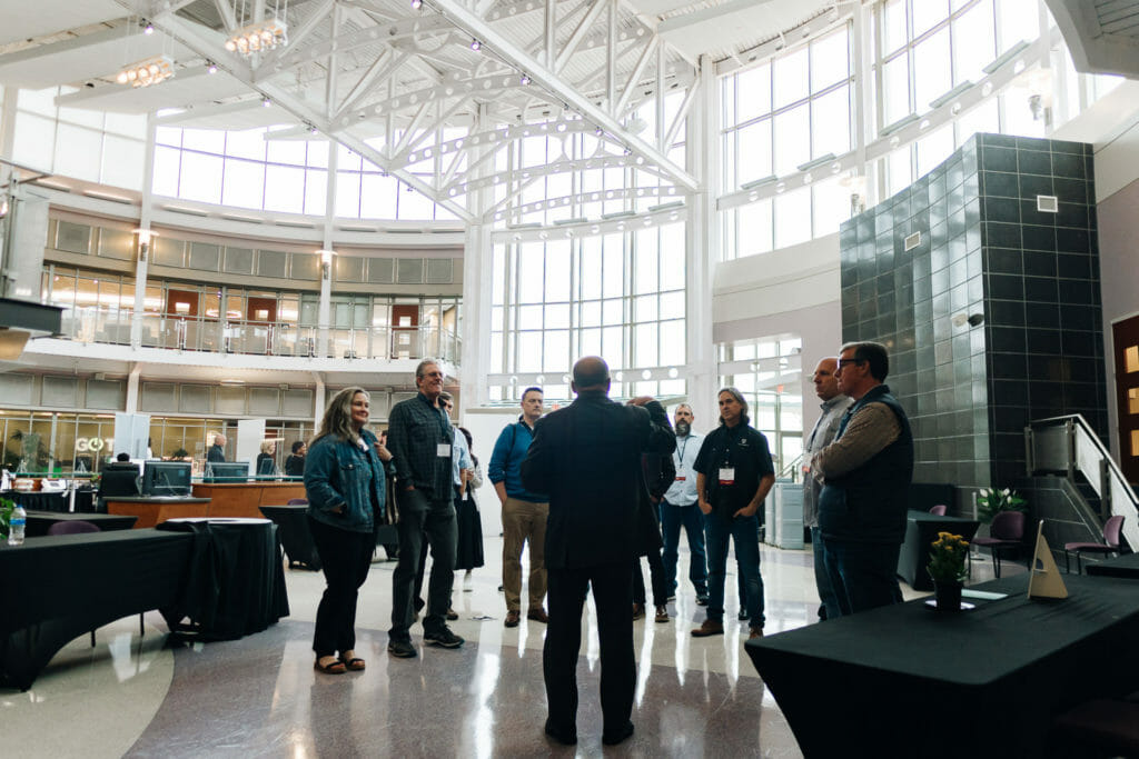 Man presents to a group in the atrium of IALR