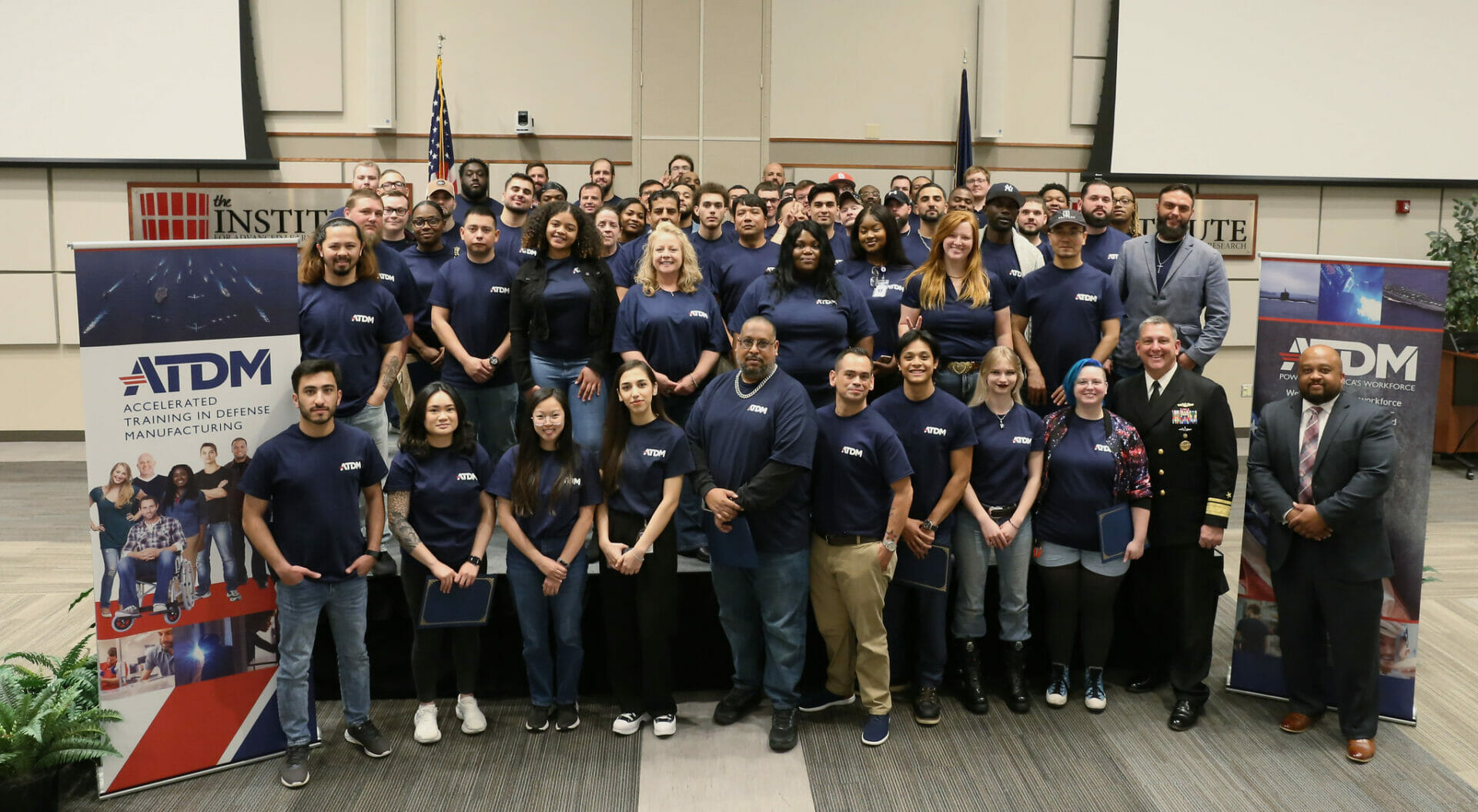 A group of 50+ ATDM graduates pose for a picture at the Institute for Advanced Learning and Research